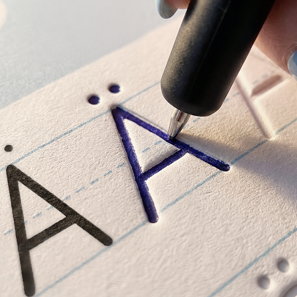 Close-up: the pen follows the groove in a letter